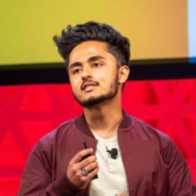 Candid close-up image of Adit Abraham on stage giving a presentation