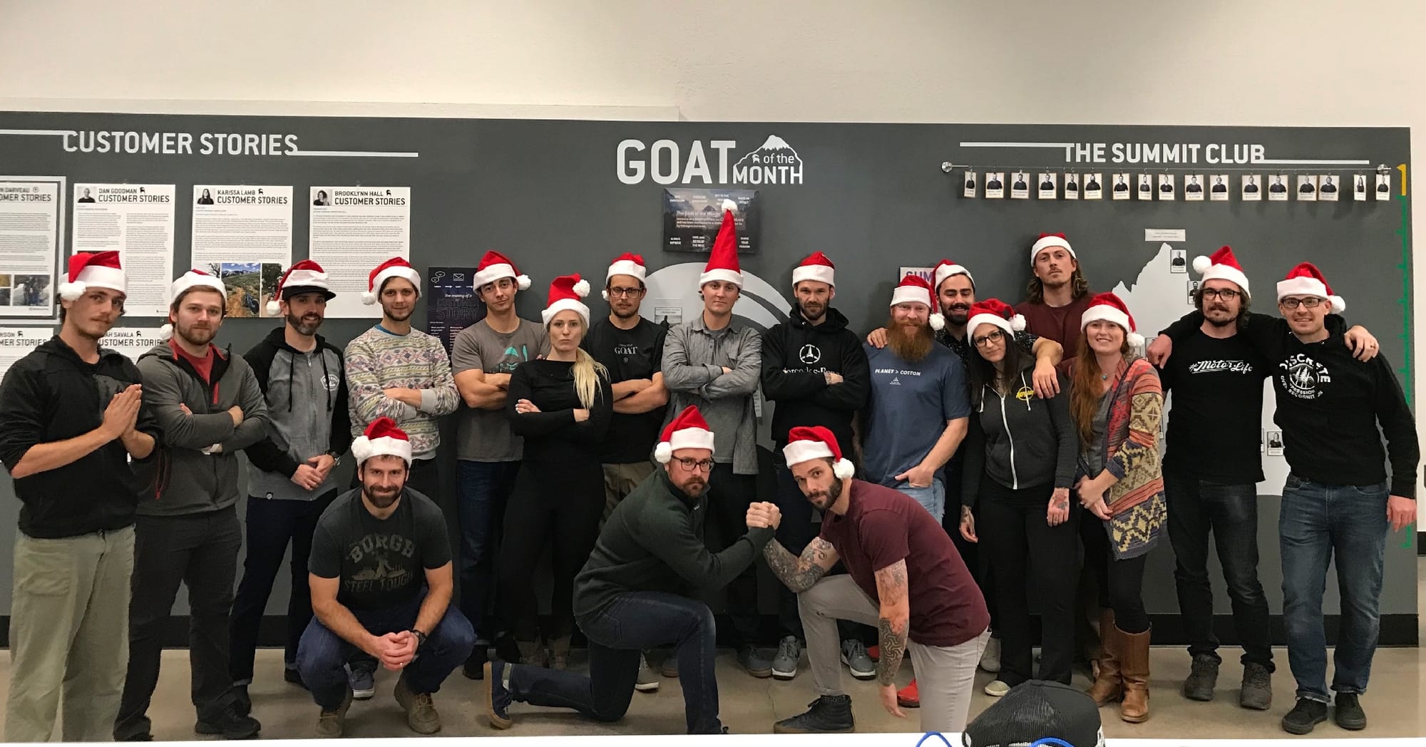 A group of Gearheads in front of Backcountry's Customer Stories wall.